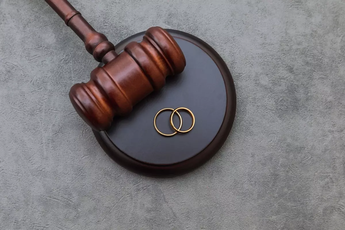 Judge's gavel with wedding rings