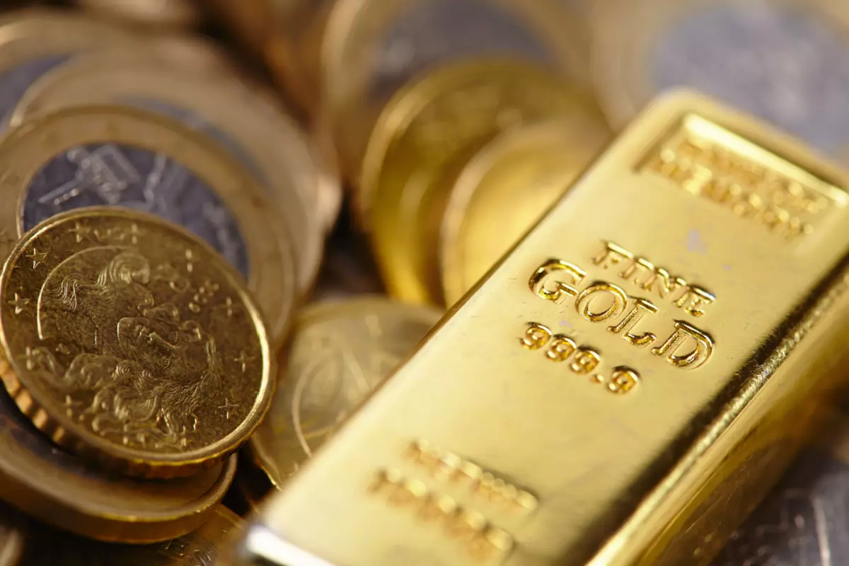 Close up on gold bar and coins
