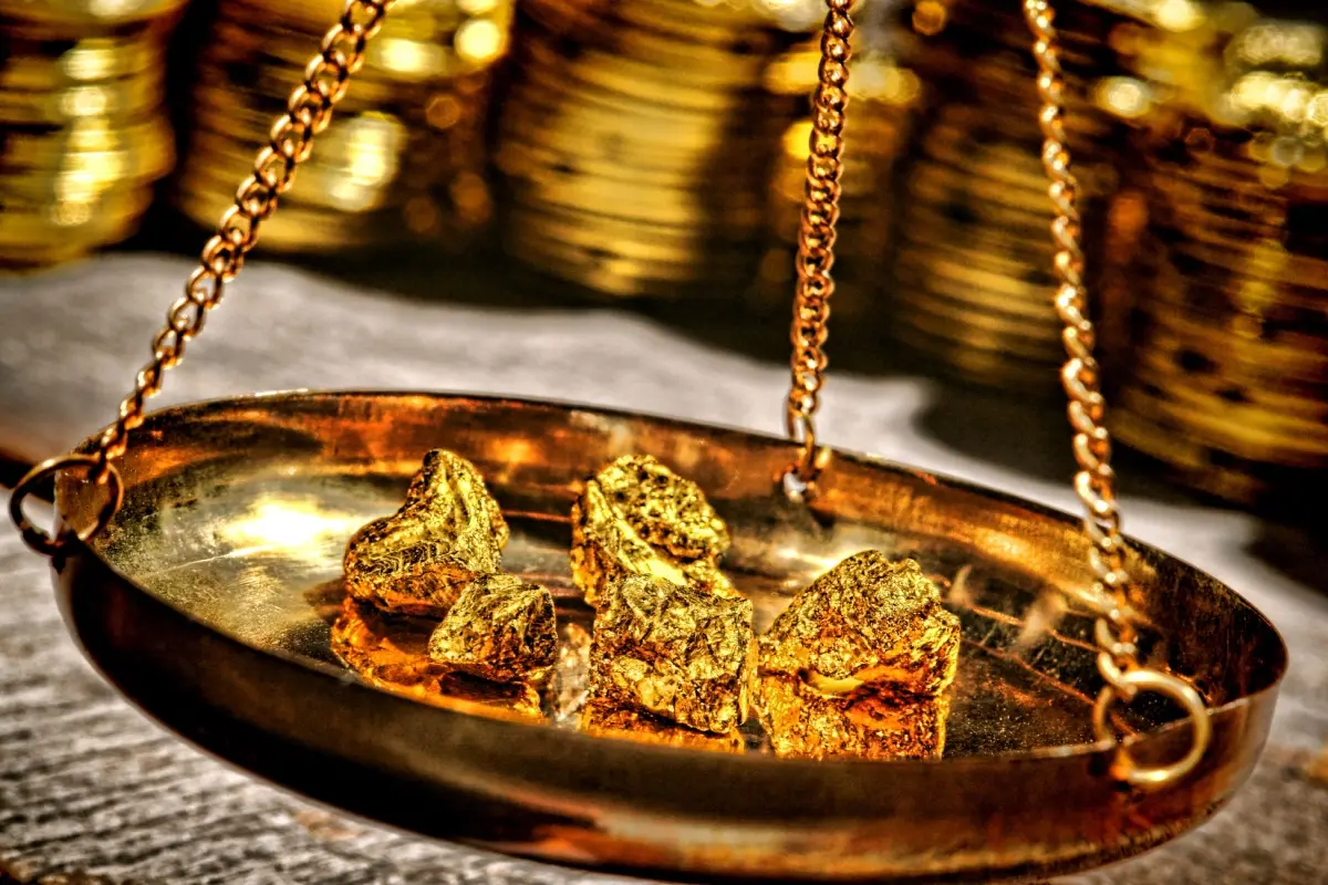 Scale holding nuggets of gold